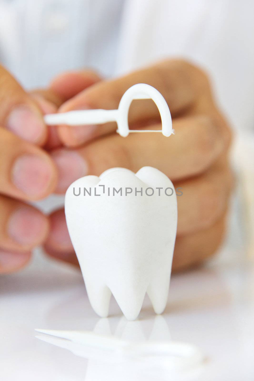 flossing teeth concept by ponsulak