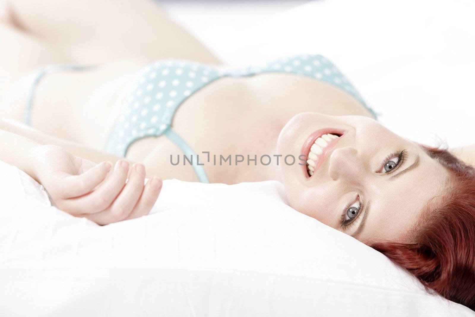 Woman in underwear on bed by studiofi