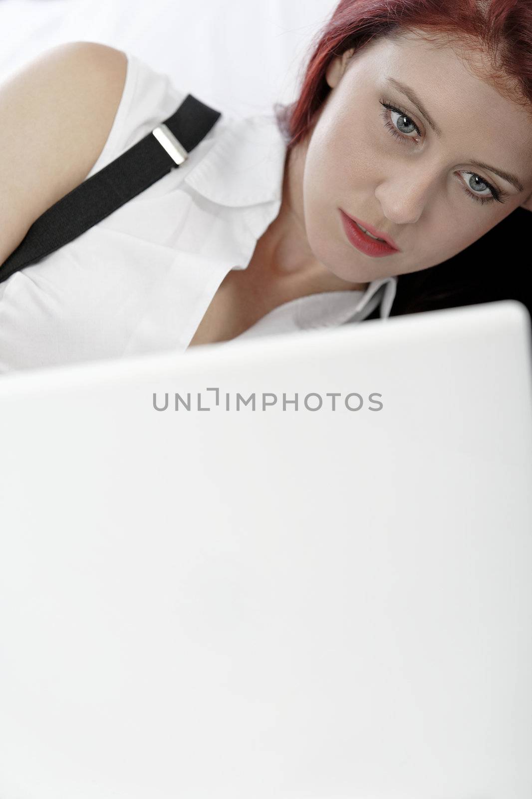 Business woman resting on bed by studiofi