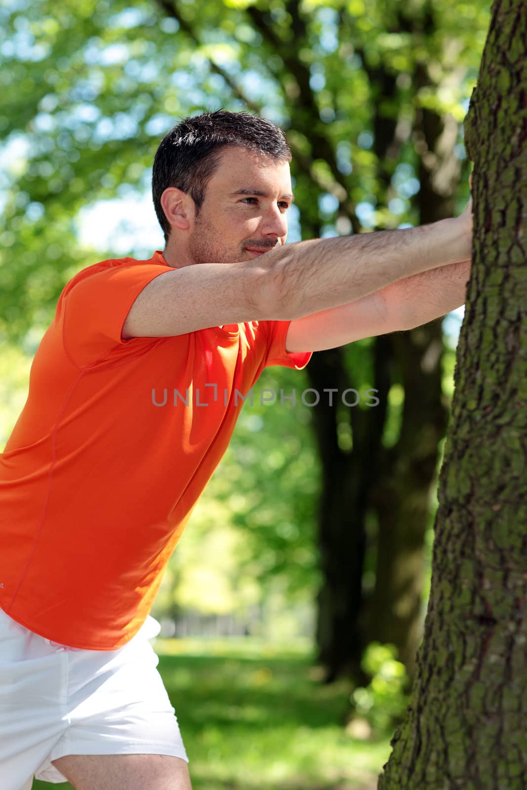 attractive man doing sport in a park