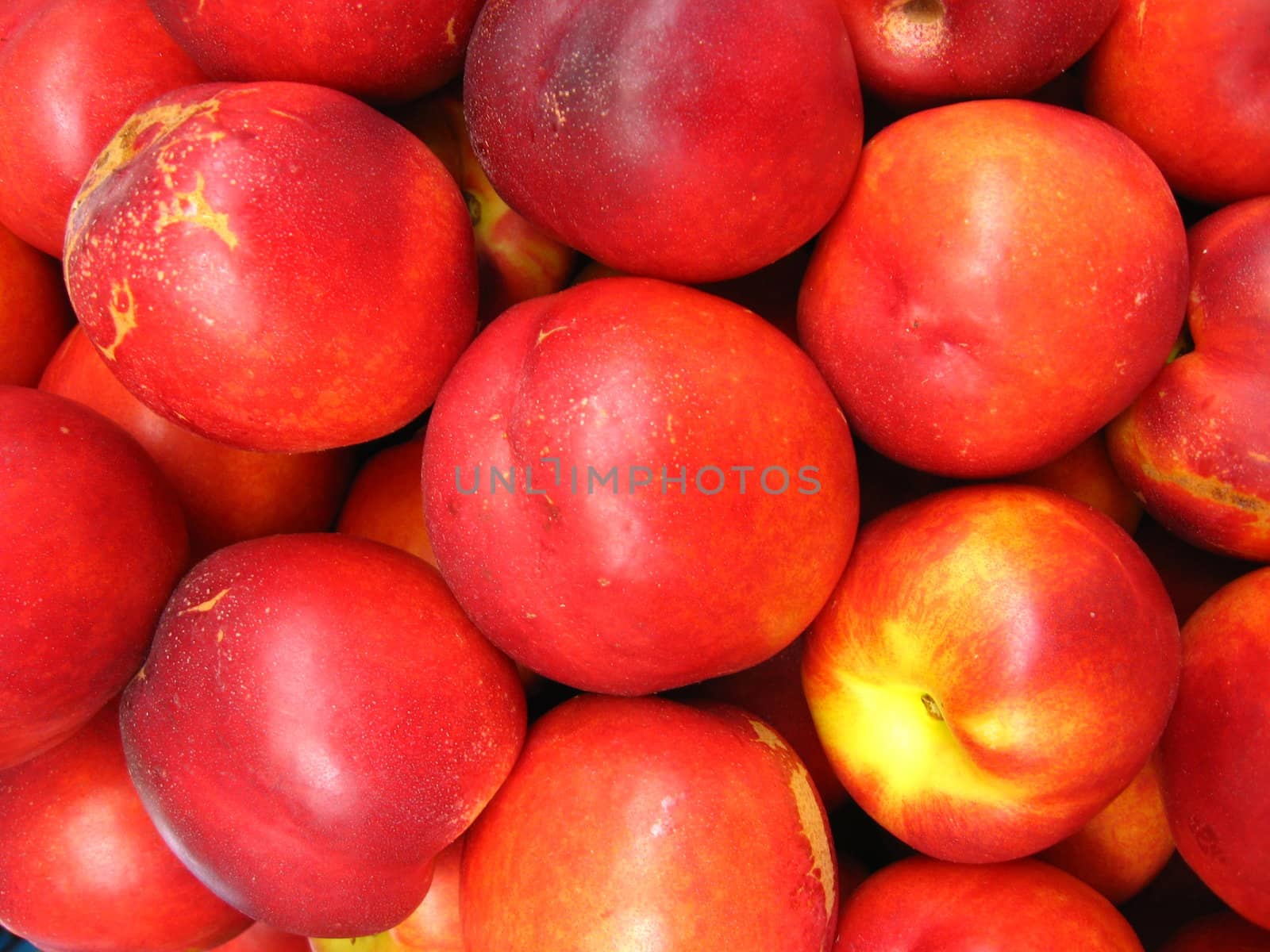 the image of a lot of red nectarines
