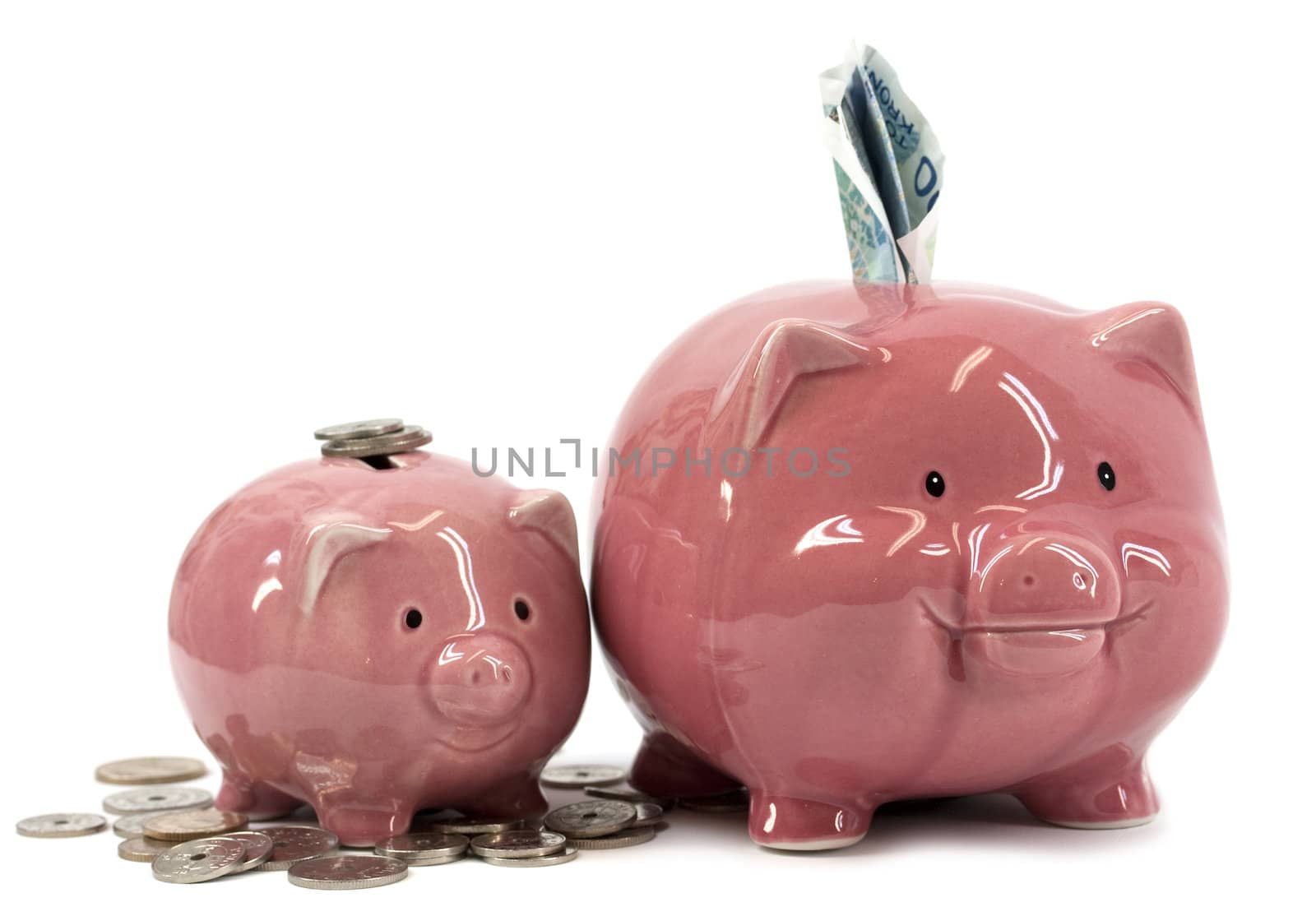 Small and larger piggy banks with coins and notes