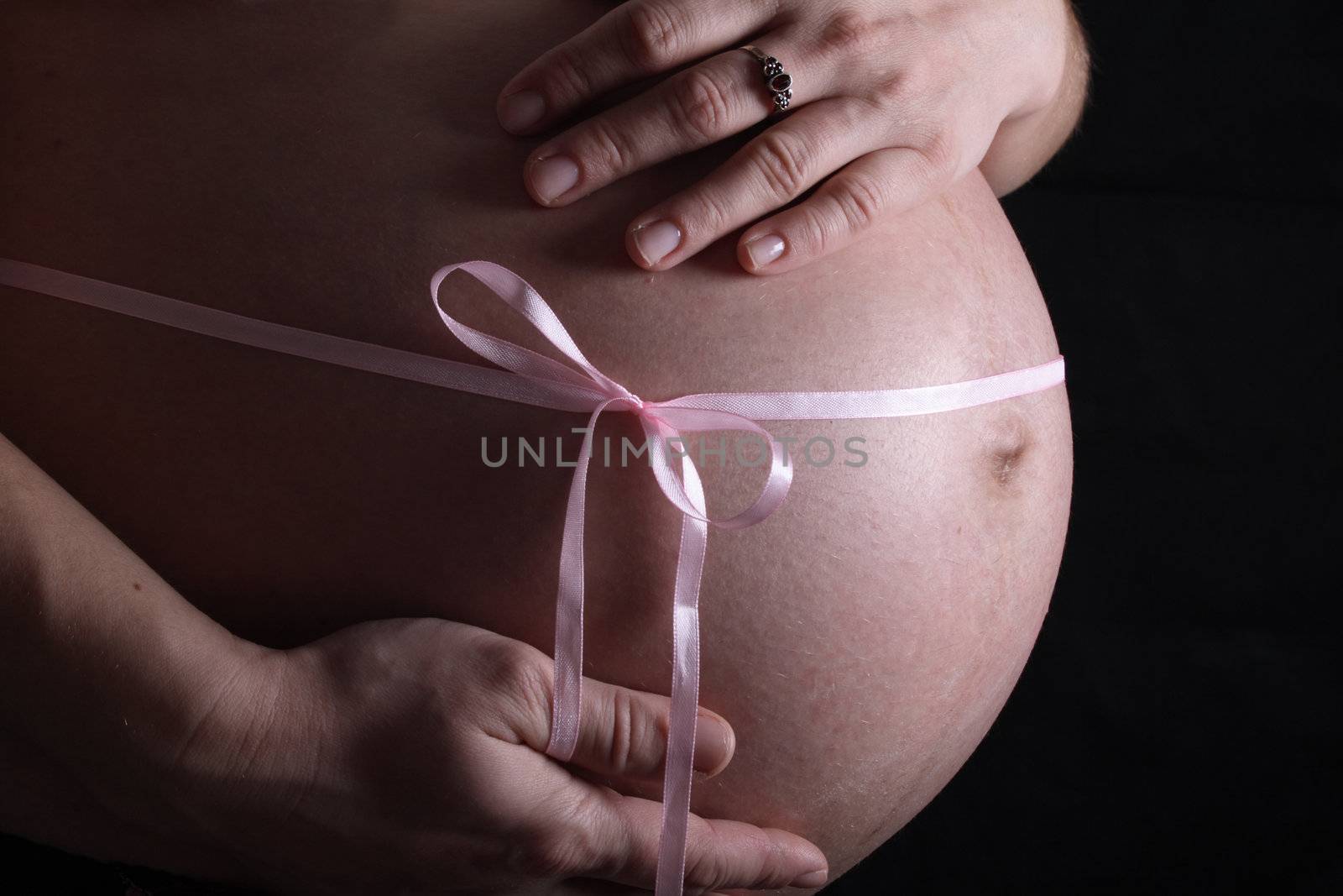 detail of young mother  on the black background