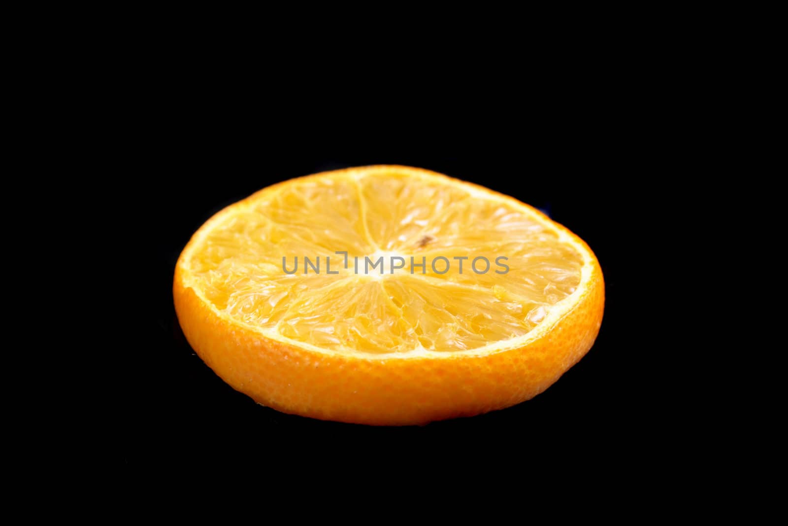 slice of orange on the black background