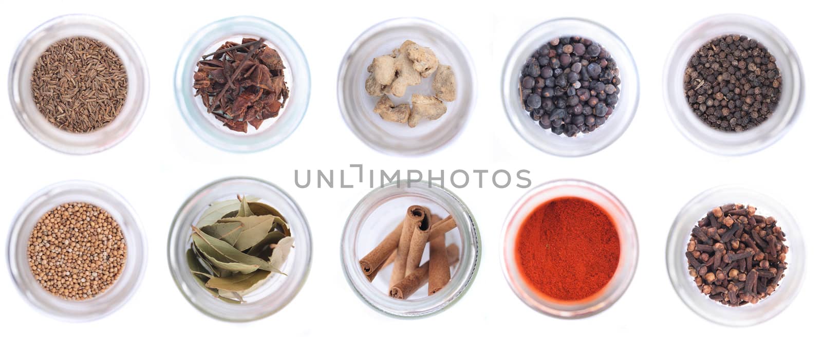 different spices in the glass on the white background