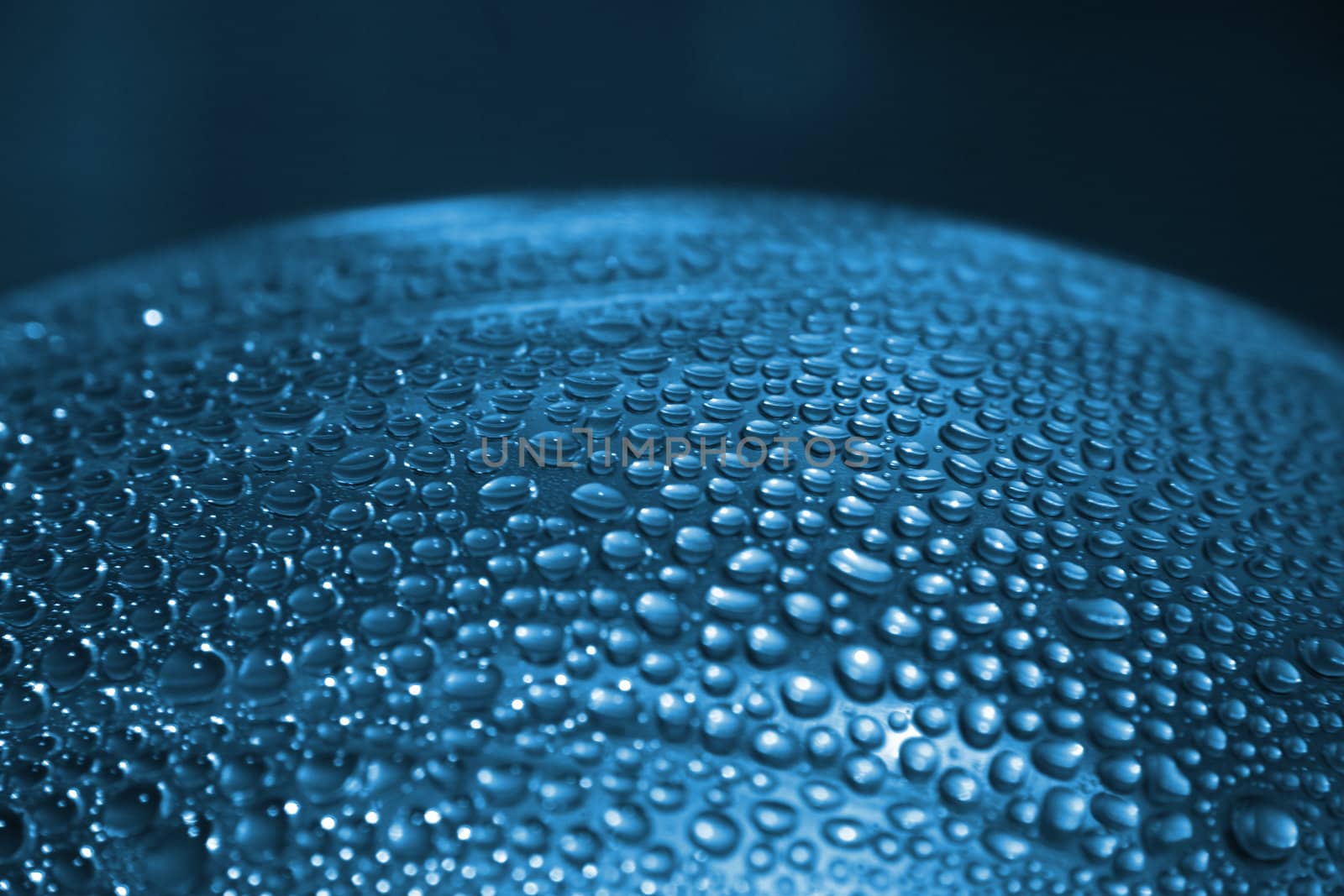 water drops texture on the glass in the blue color