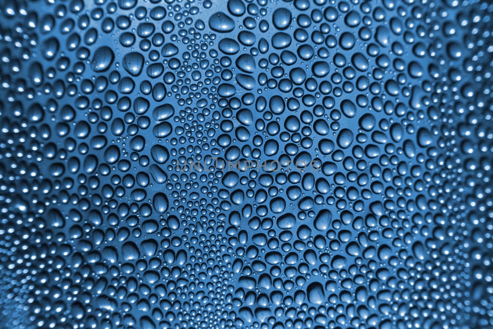 water drops texture on the glass in the blue color