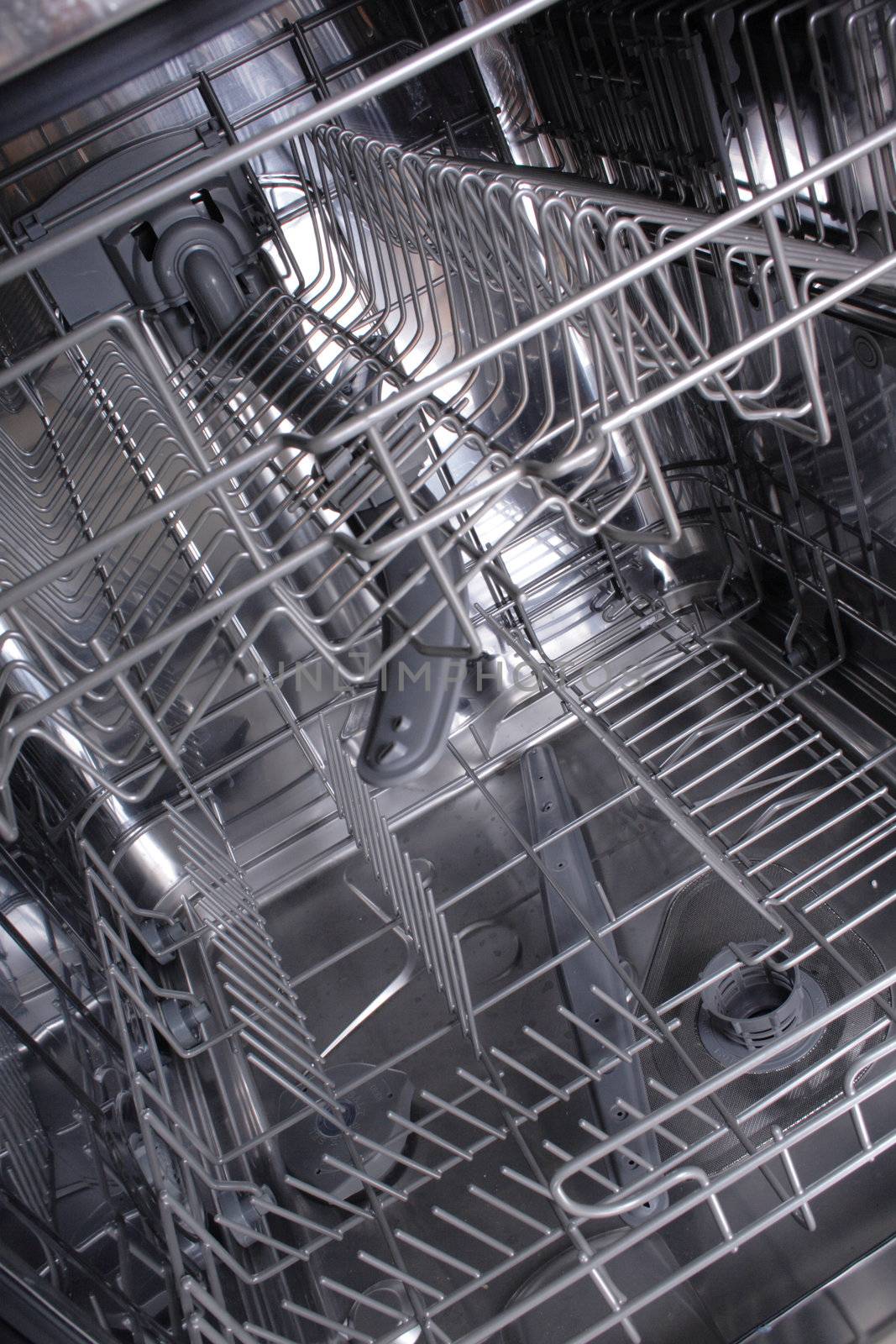 inside of empty and clear dishwasher machine 