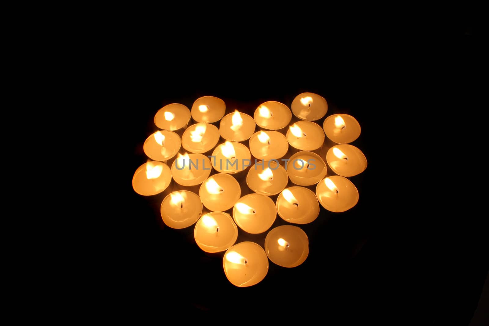 heart from the candles on the black background