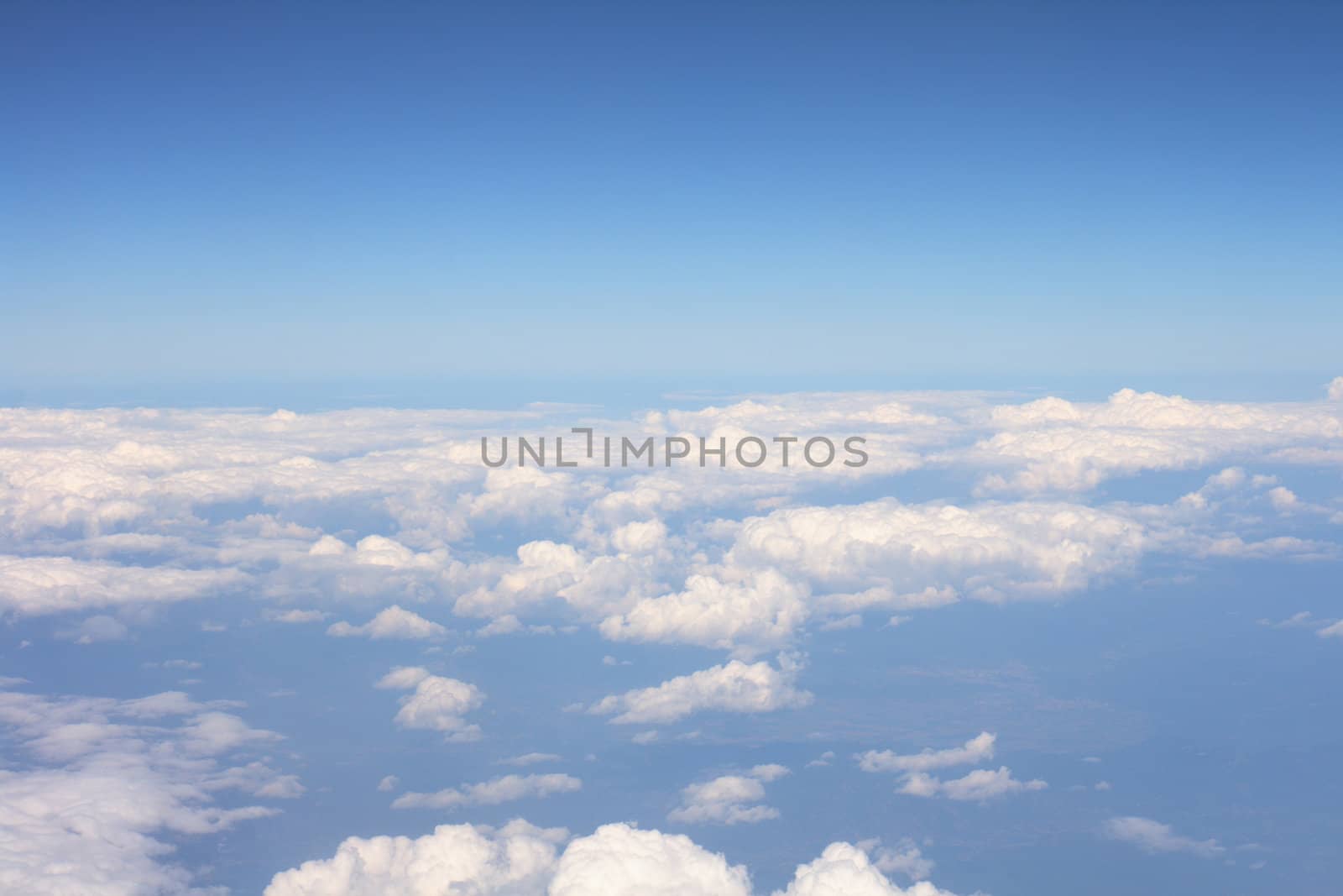 white clouds from the sky onm the blue background