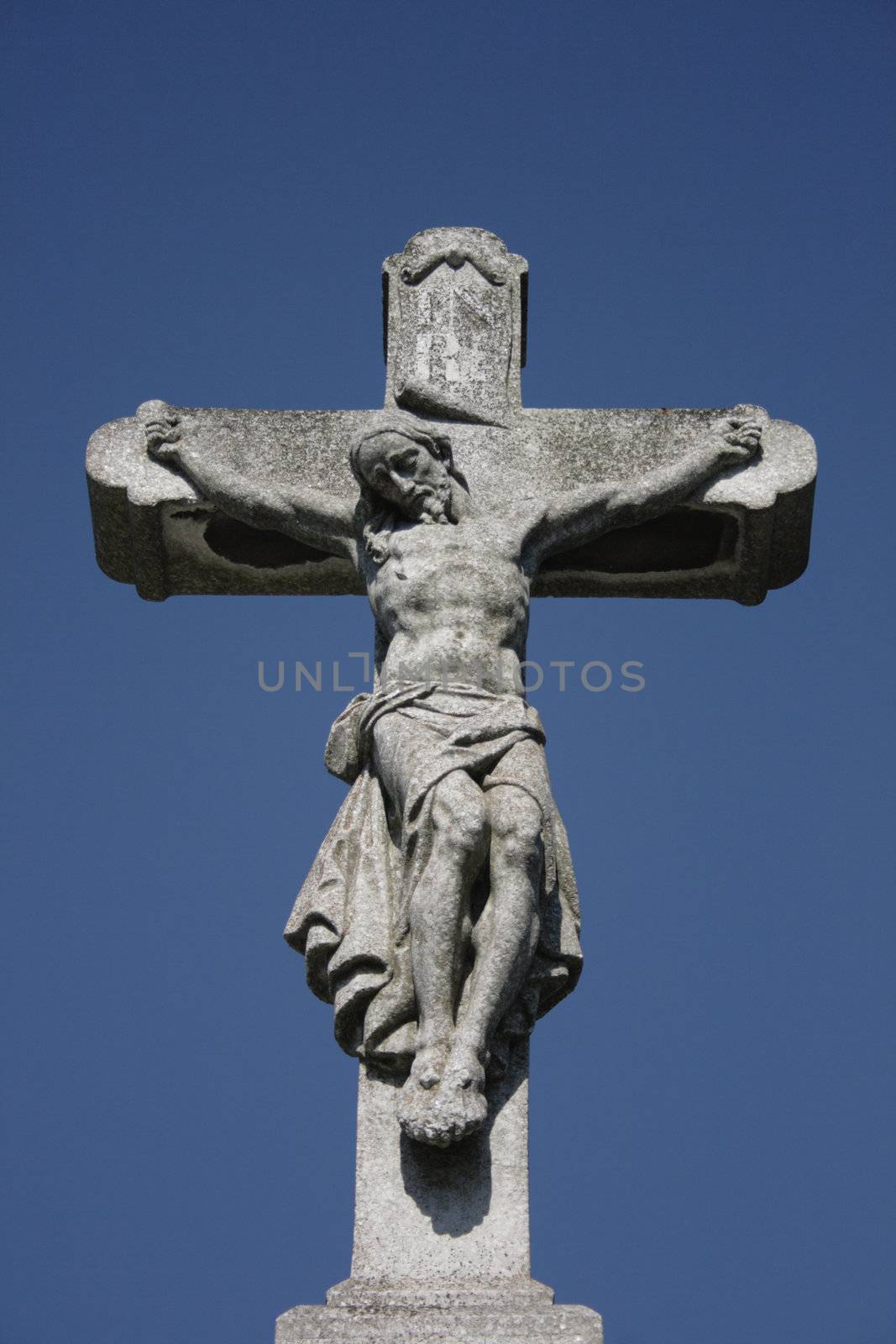 crucifix and blue sky from the burial place