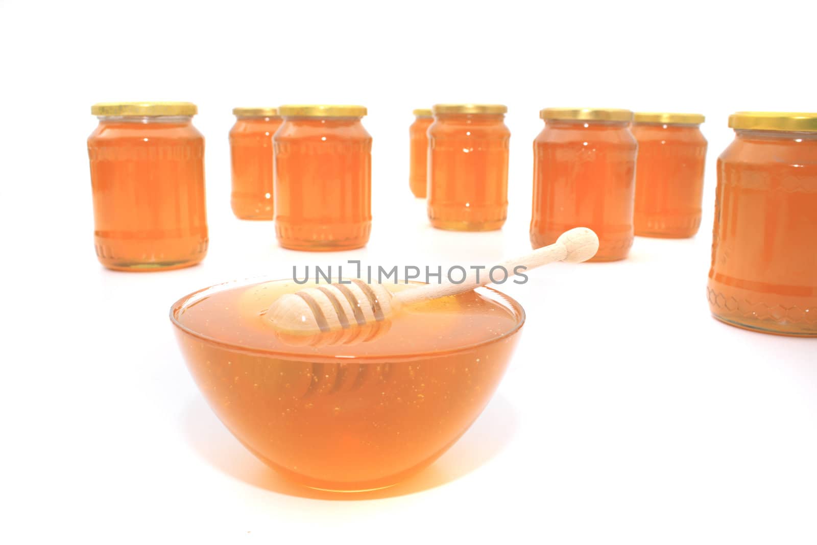 glass with honey isolated on the white background
