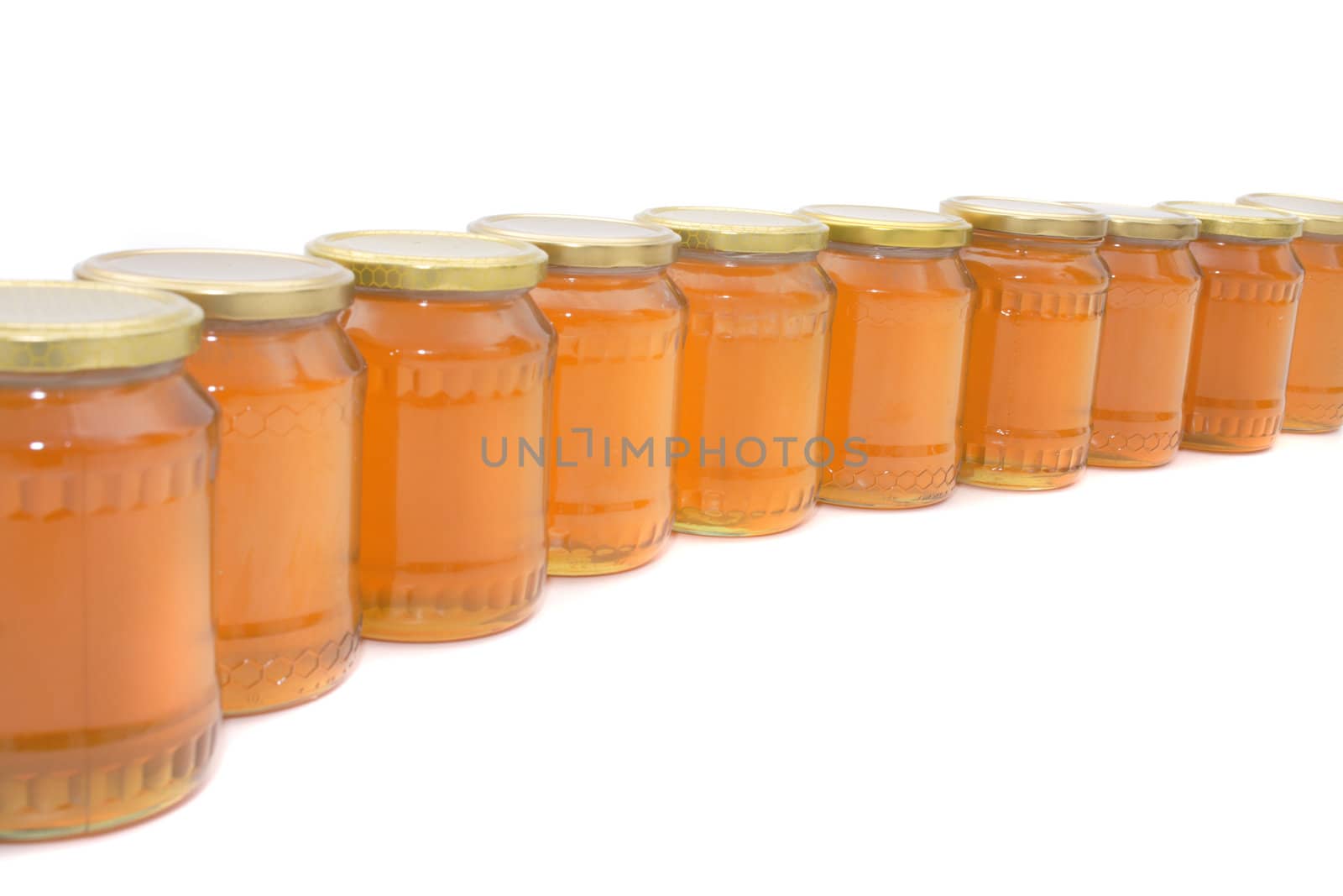 glasses of honey isolated on the white background