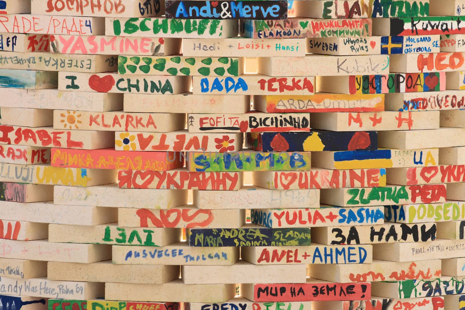 wooden brick wall with names and words 
