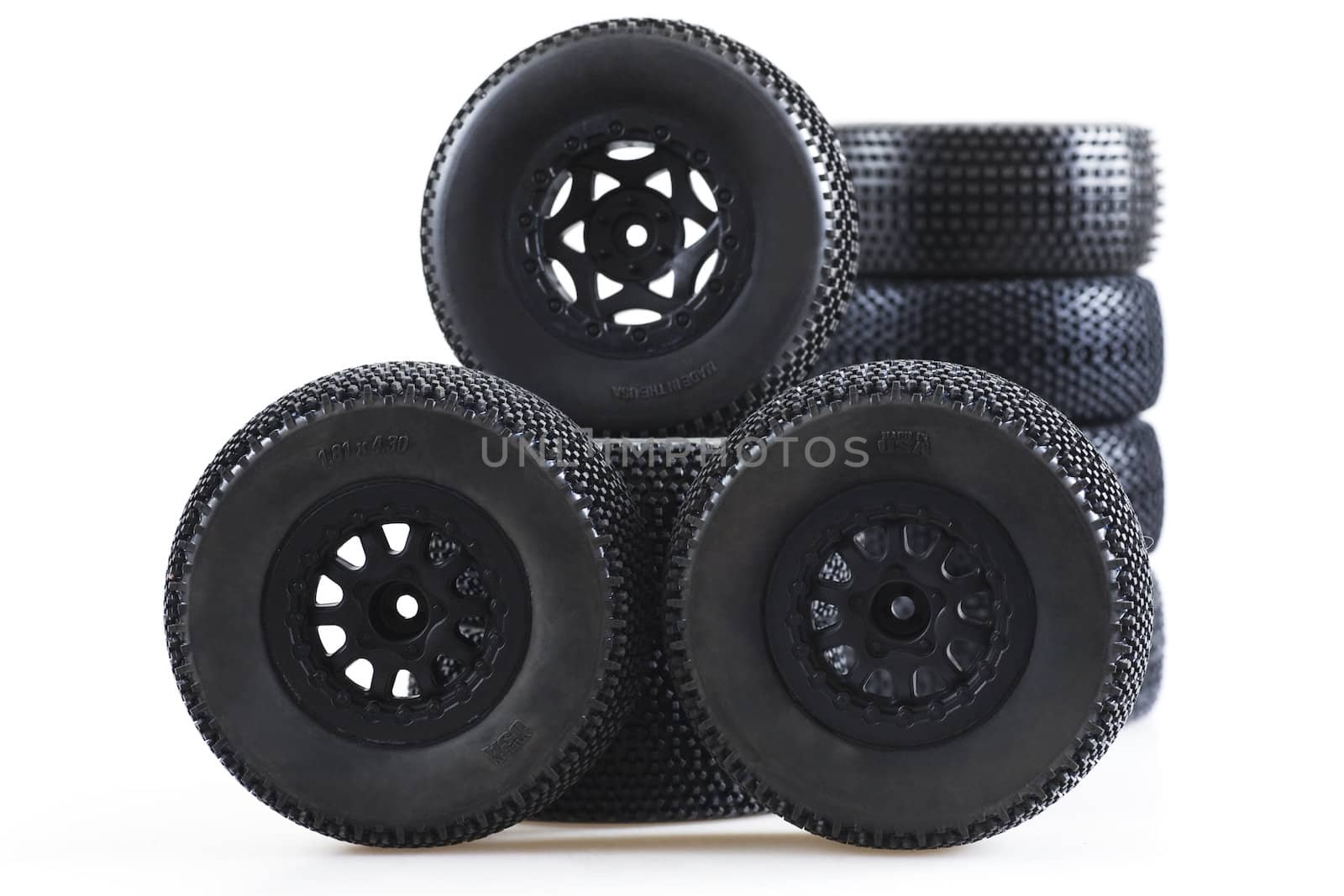 heap of wheels for radio-controlled models on a white background by Serp