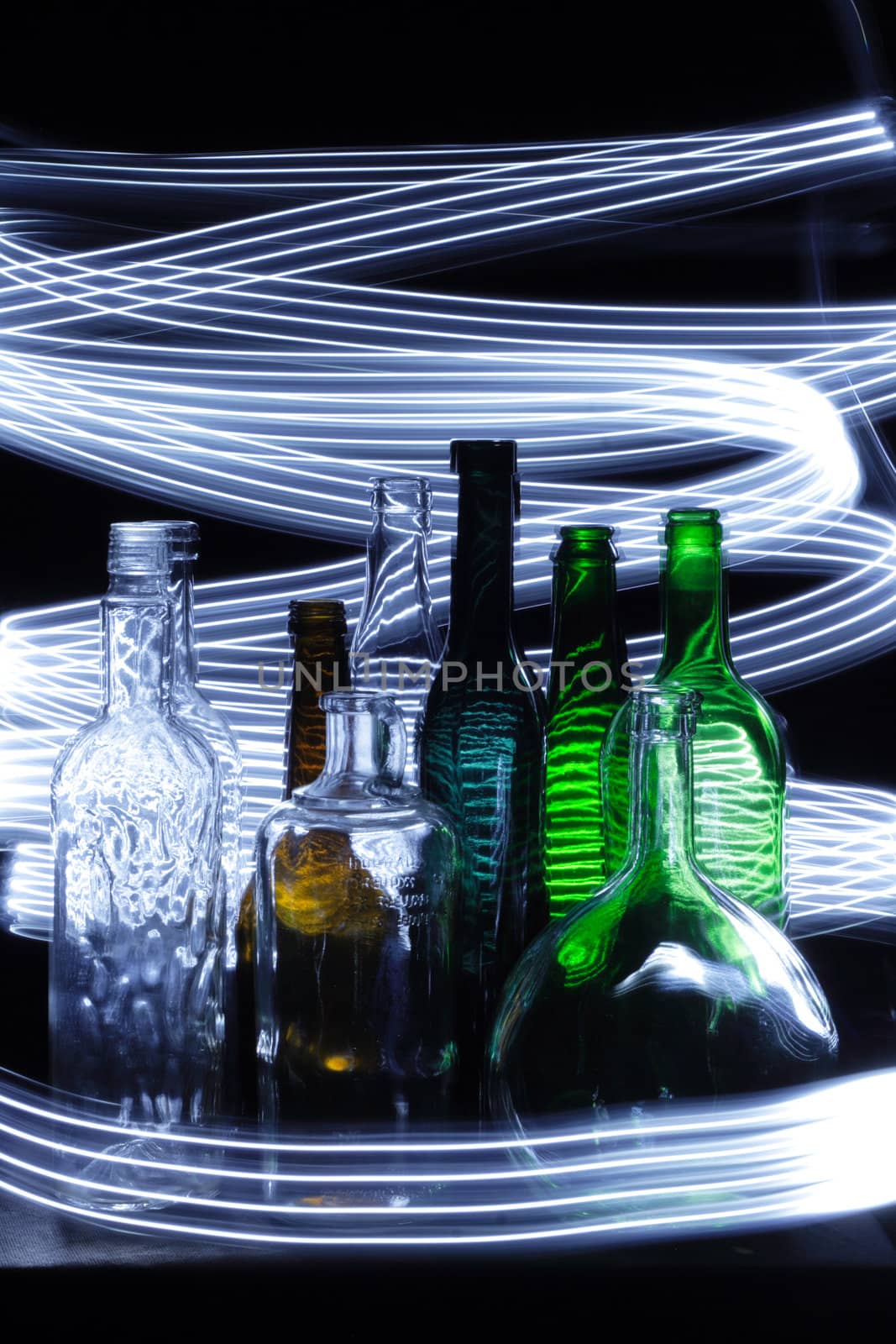 empty bottles in the night with lights curves