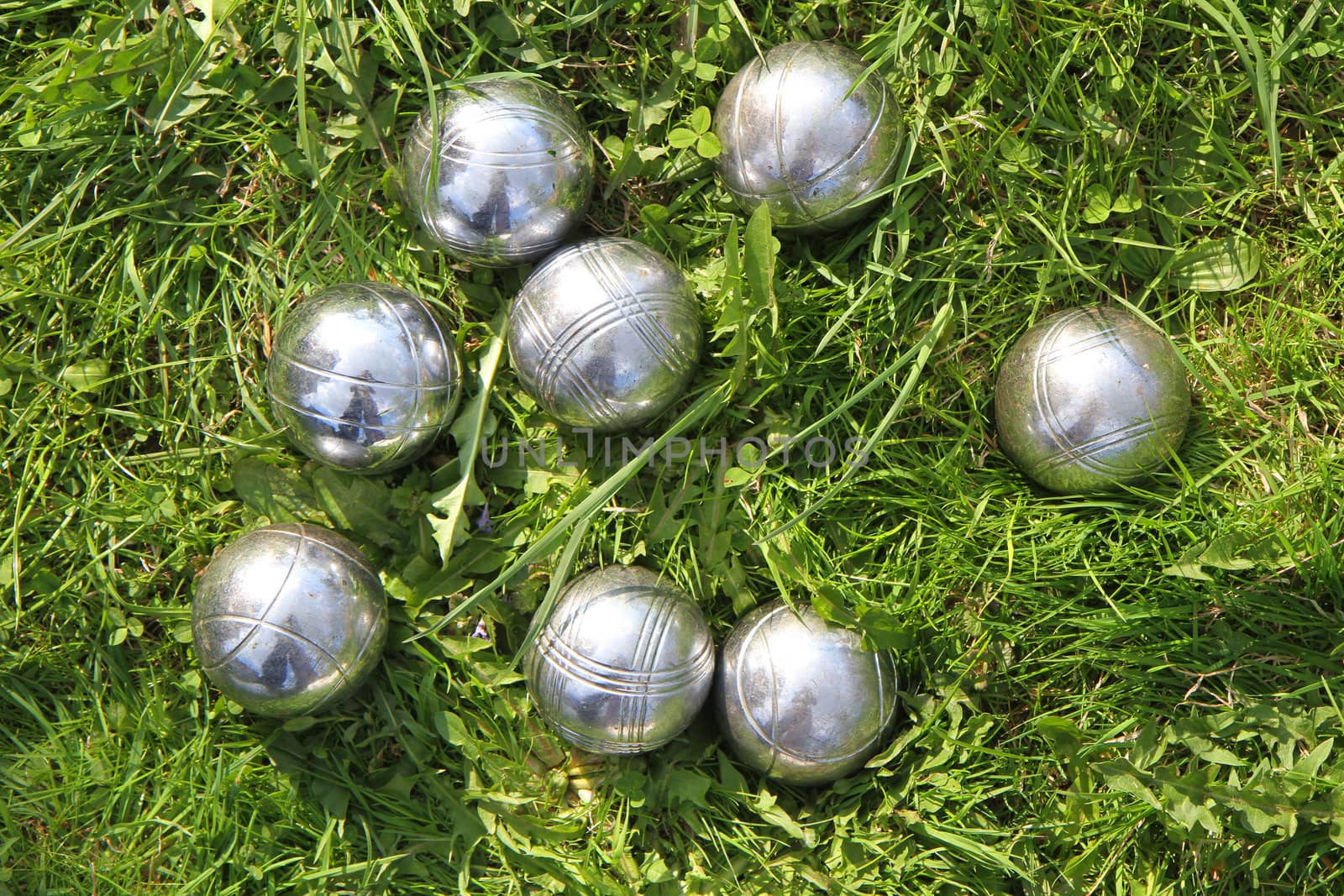 petanque bowls in the green grass as sport background