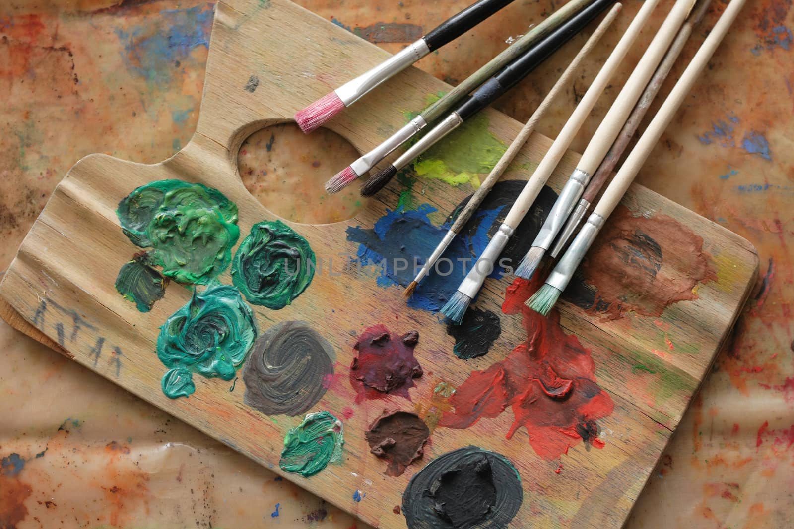paint brushes and color on the palette background