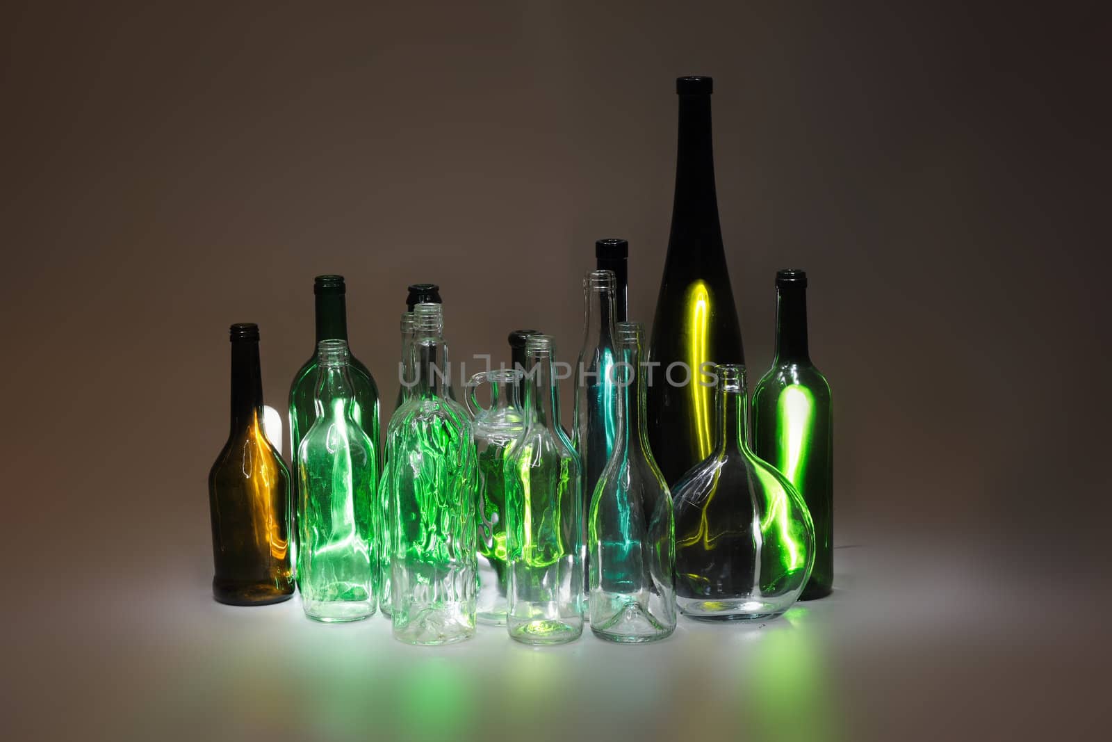 empty color glass bottles in the dark night