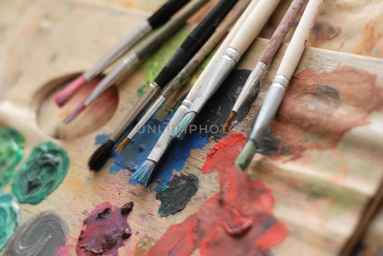 paint brushes and color on the palette background