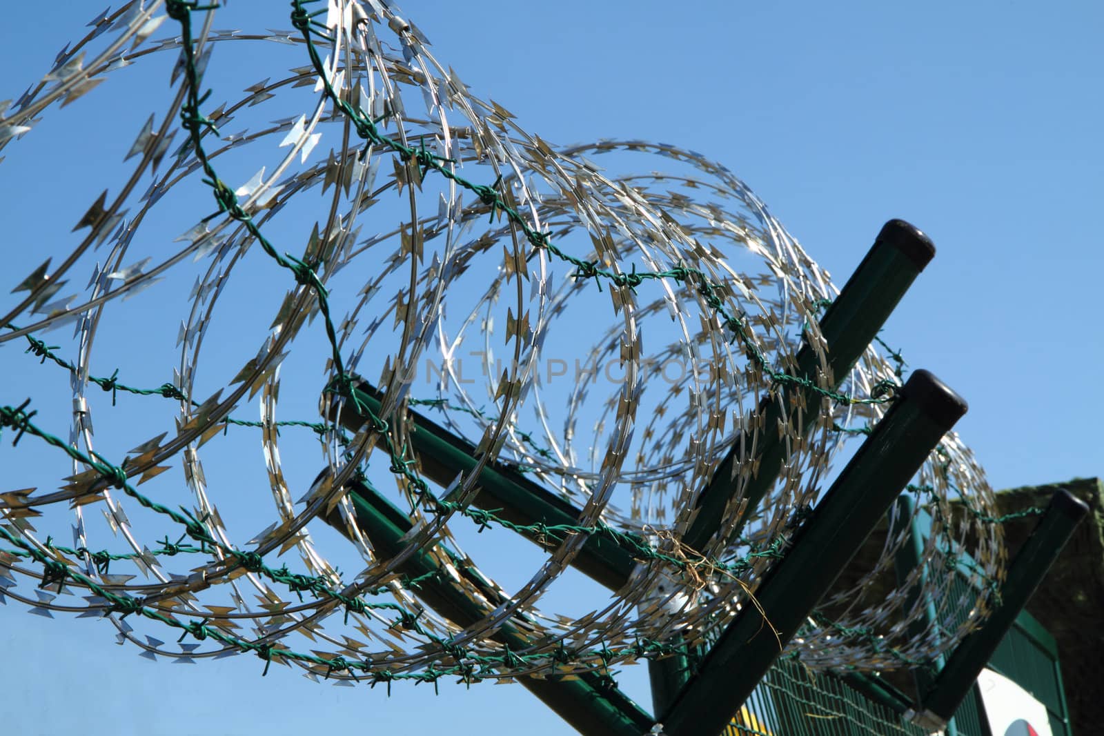 barbed wire against blue sky as war  background