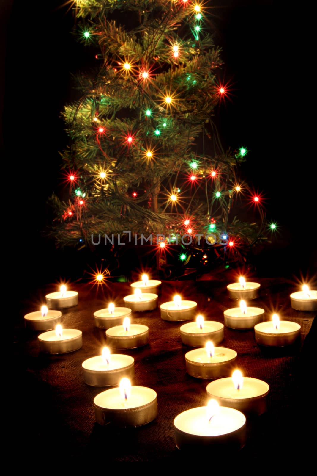 candles and the christmas tree in the dark night 