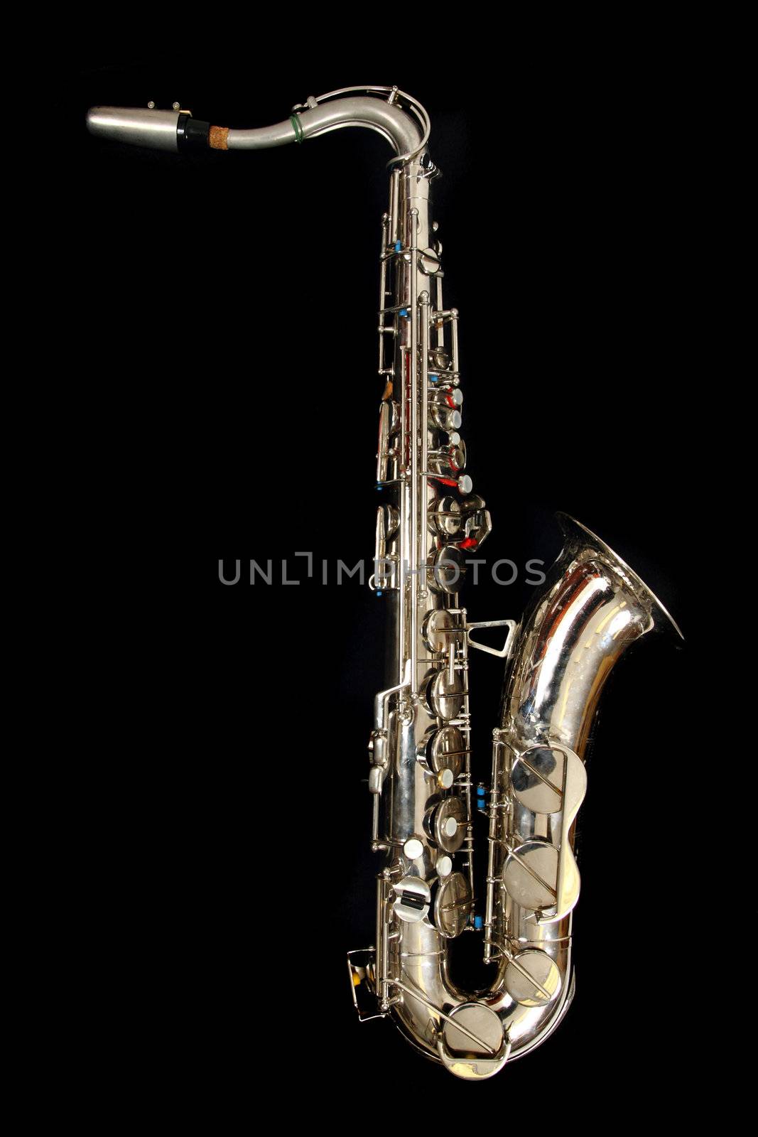 old saxophone isolated on the black background
