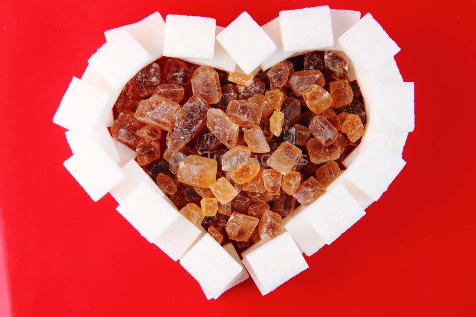 valentine heart from the sugar on the red background