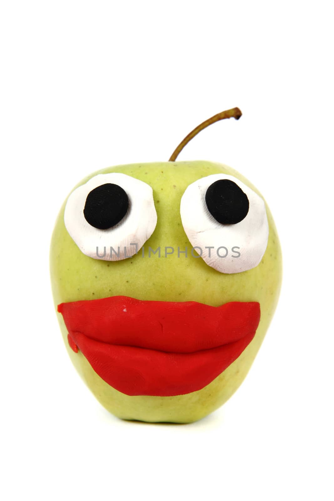 green apple with plasticine smile isolated on the white background