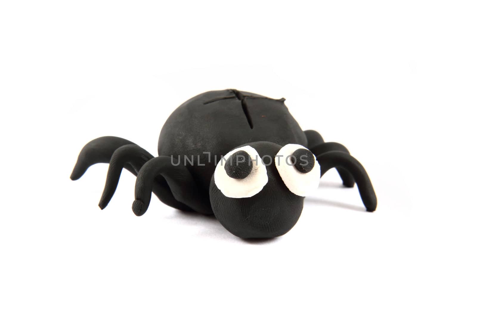 black spider from the plasticine isolated on the white background