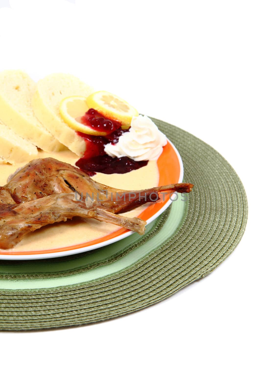 rabbit legs and carrot sauce isolated on the white background