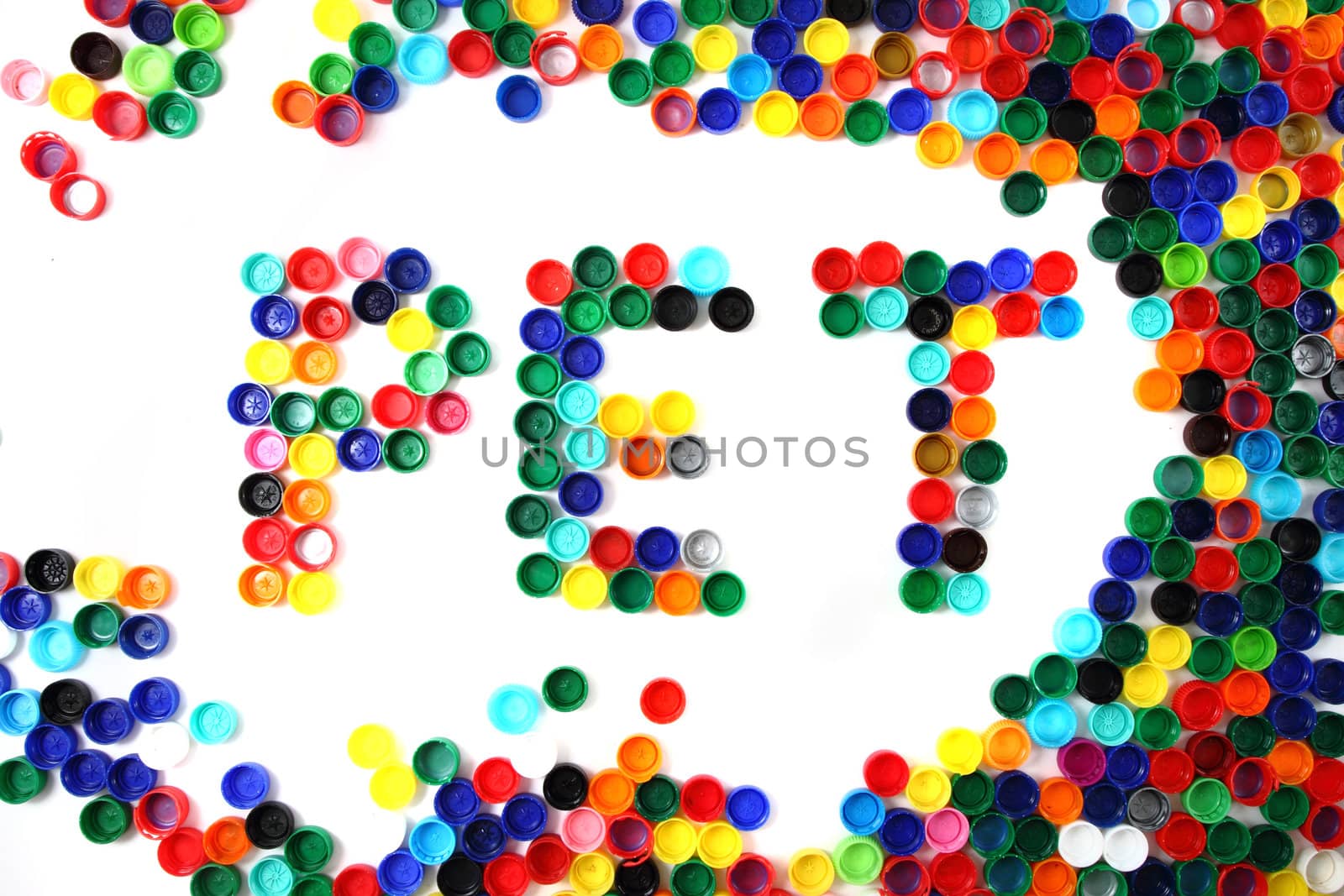 word pet from color plastic caps isolated on the white background