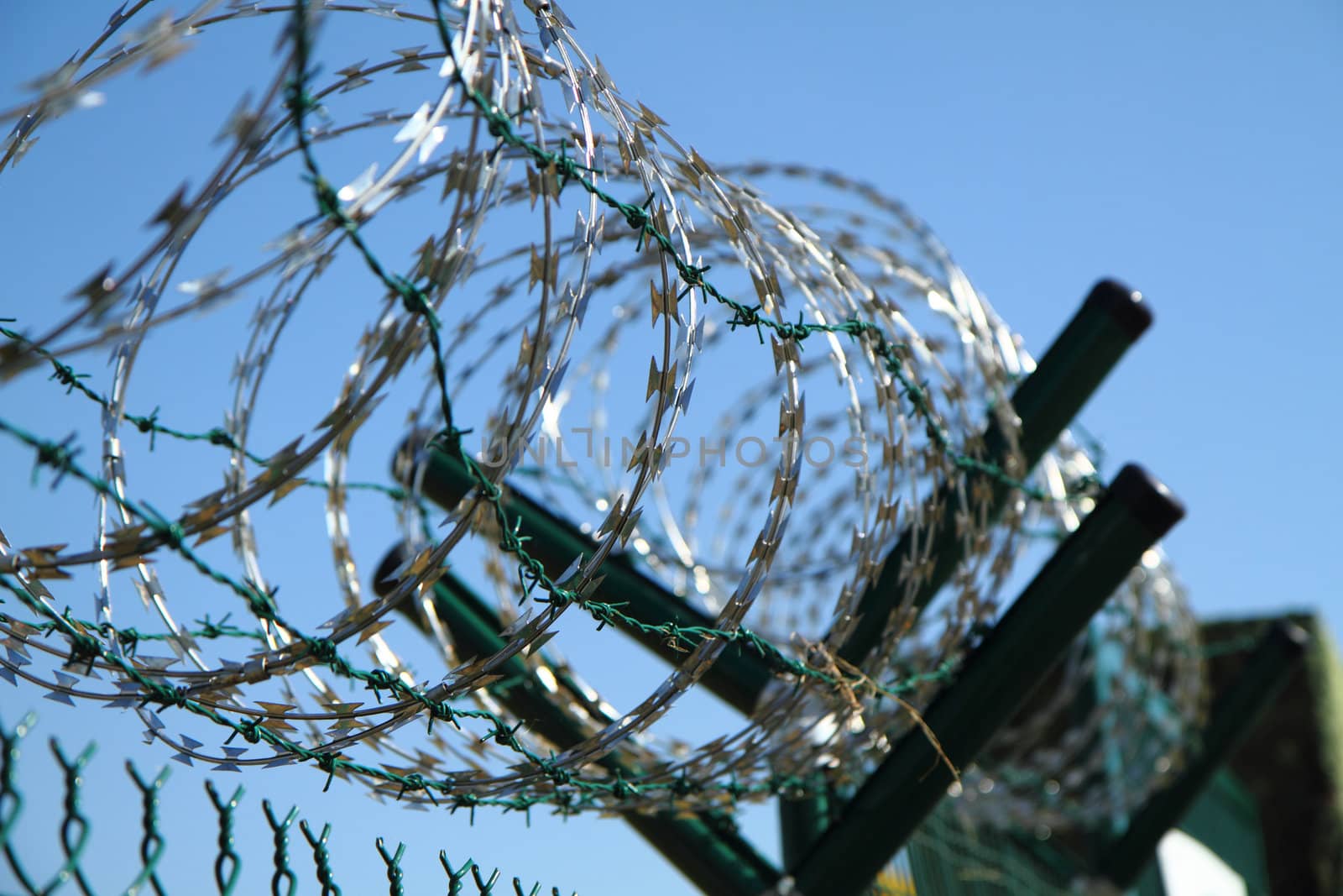 barbed wire against blue sky  by jonnysek