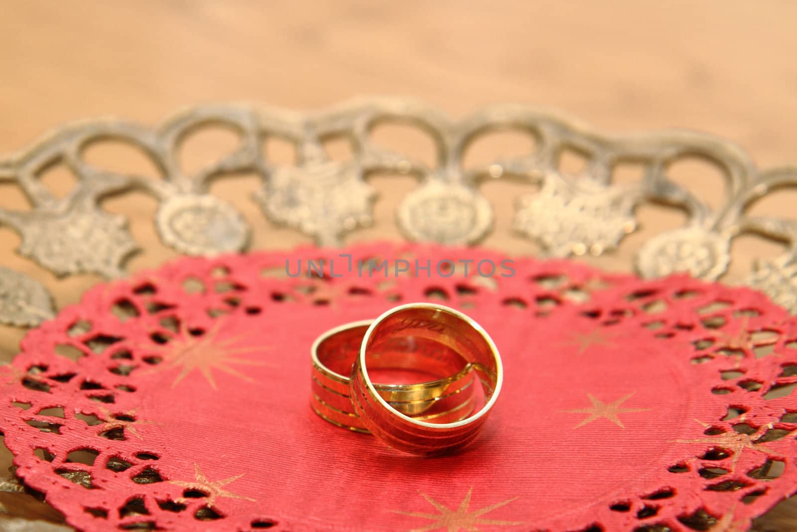golden wedding rings on the red background