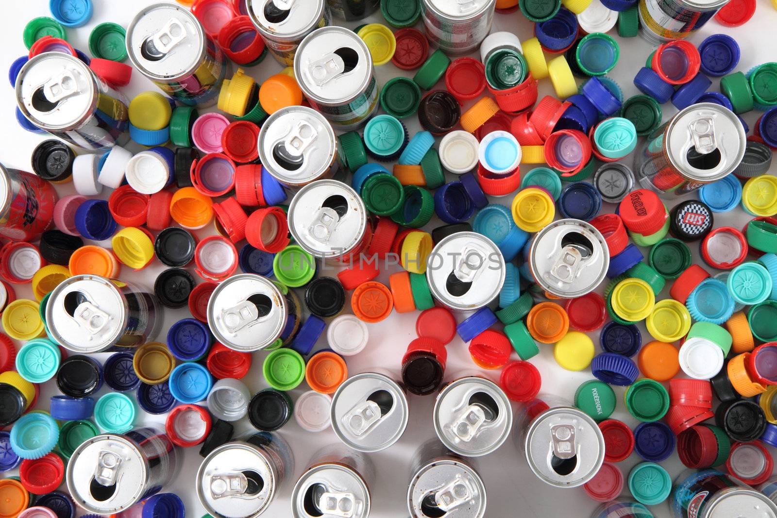 plastic caps and aluminum cans as recycle background