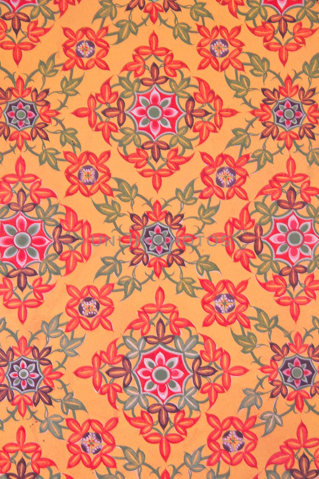 Patterns of flowers that are the backdrop of the temple wall
