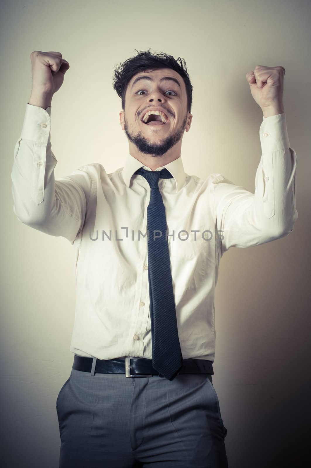 happy successful stylish businessman on gray background
