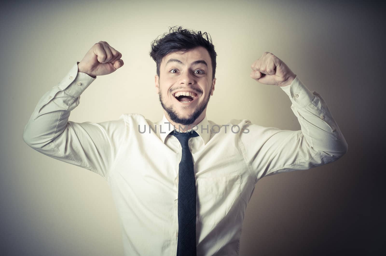 happy successful stylish businessman on gray background