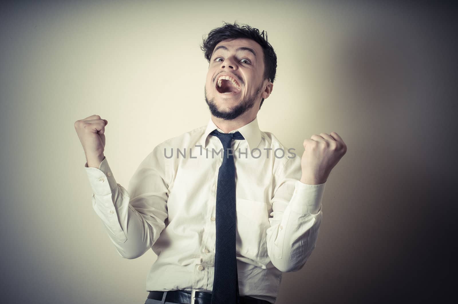happy successful stylish businessman on gray background