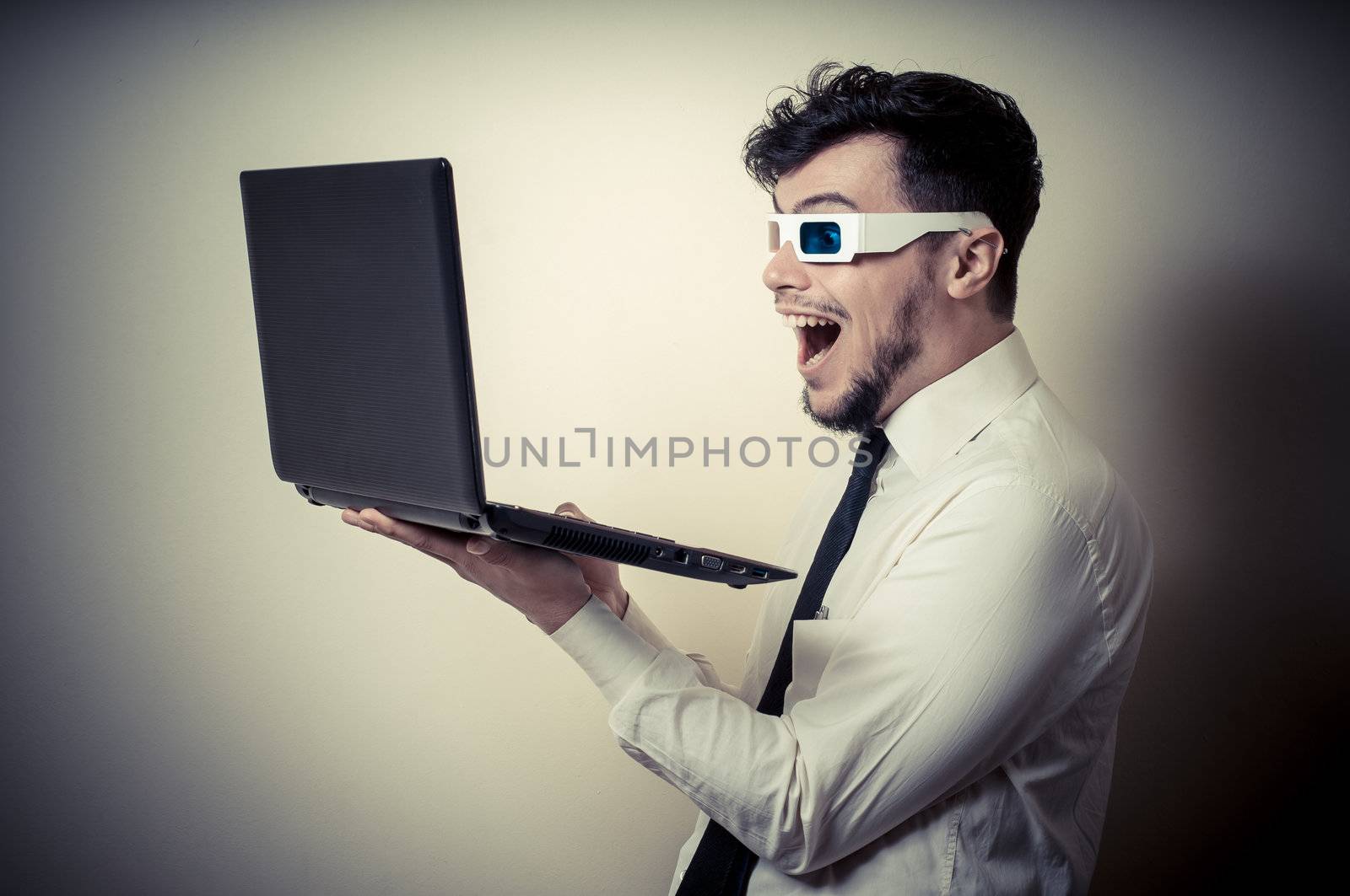 businessman with 3d eyewear watching laptop on gray background