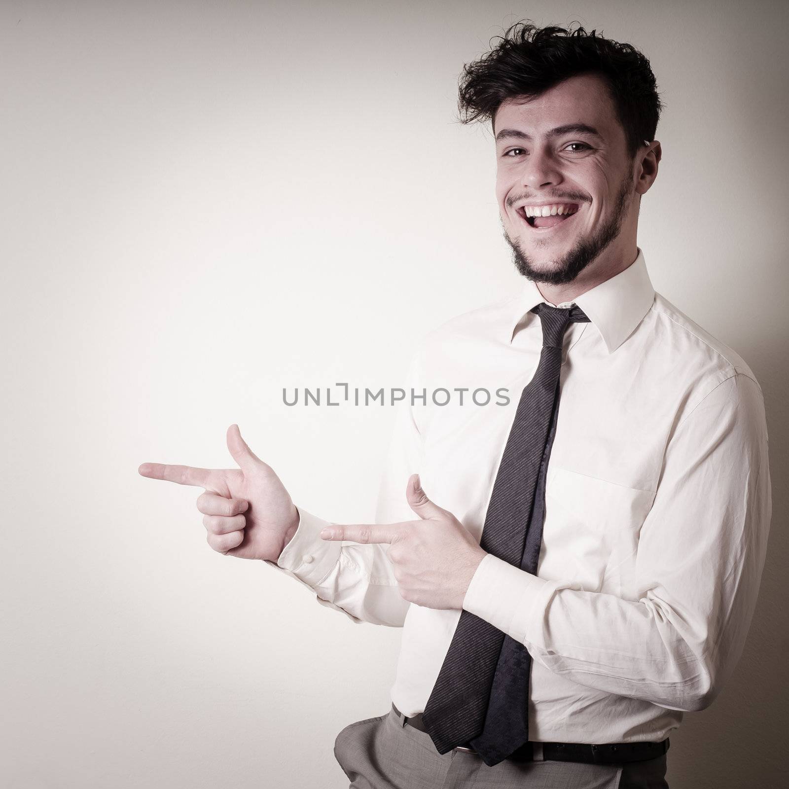 stylish modern guy with white shirt pointing by peus