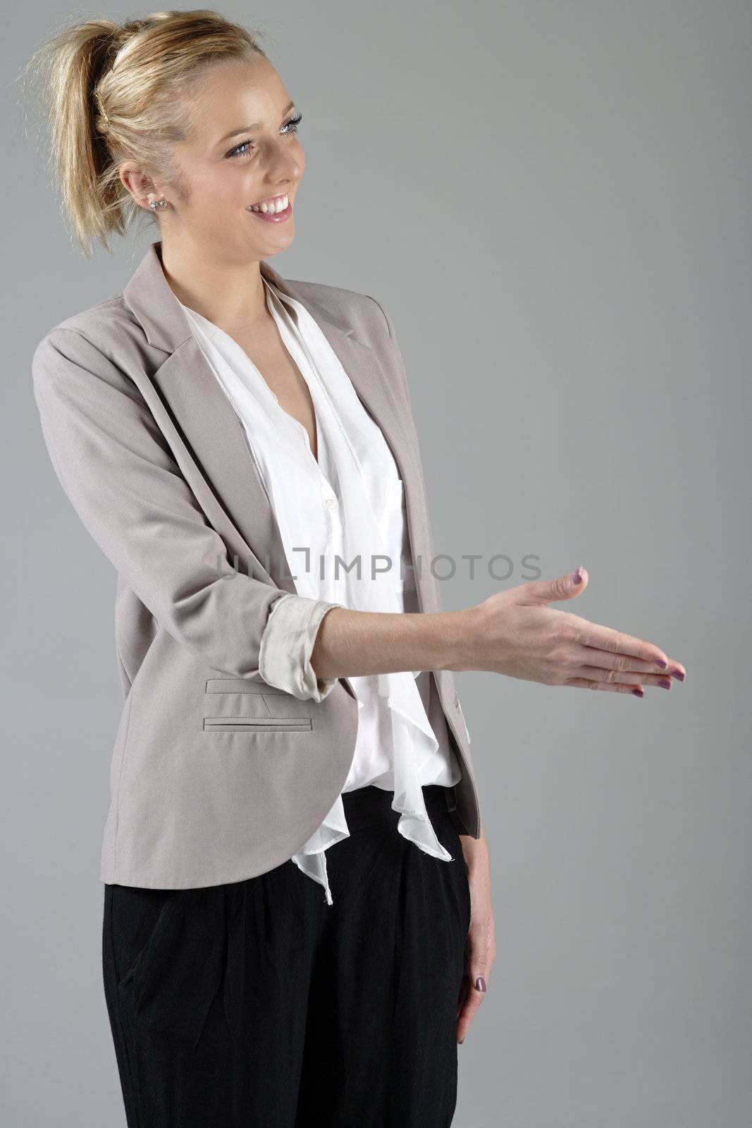 Young attractive woman offer her hand to greet a business associate
