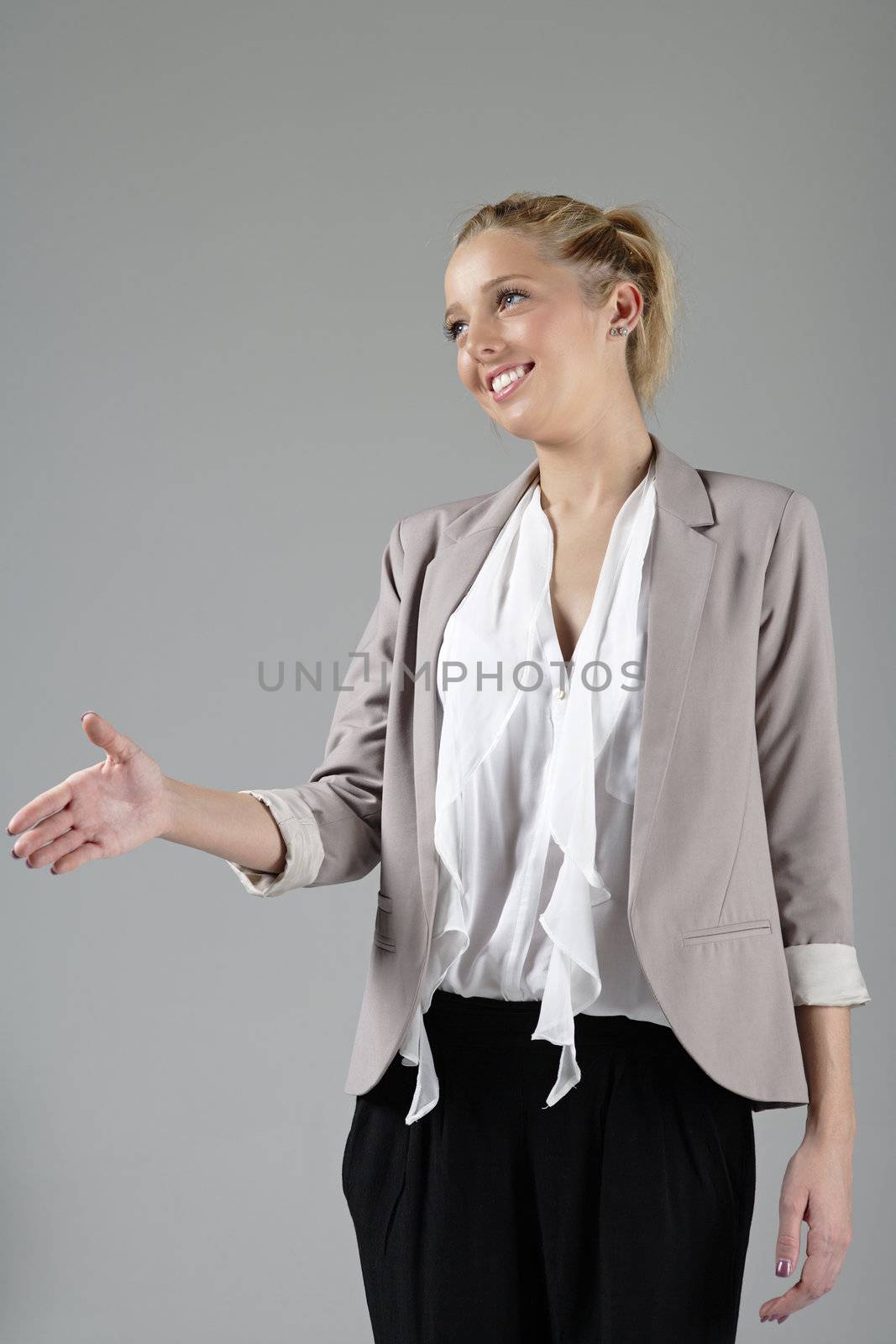Young attractive woman offer her hand to greet a business associate