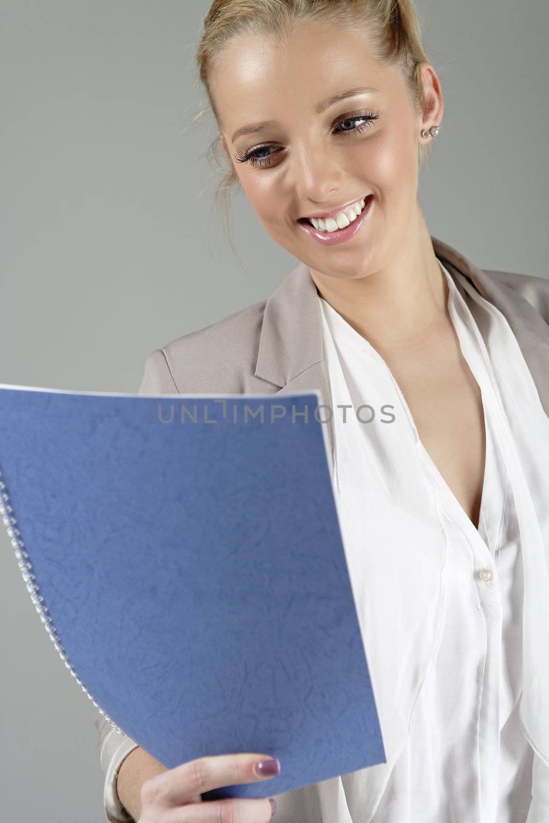 Young beautiful woman in a business suit reading documents.