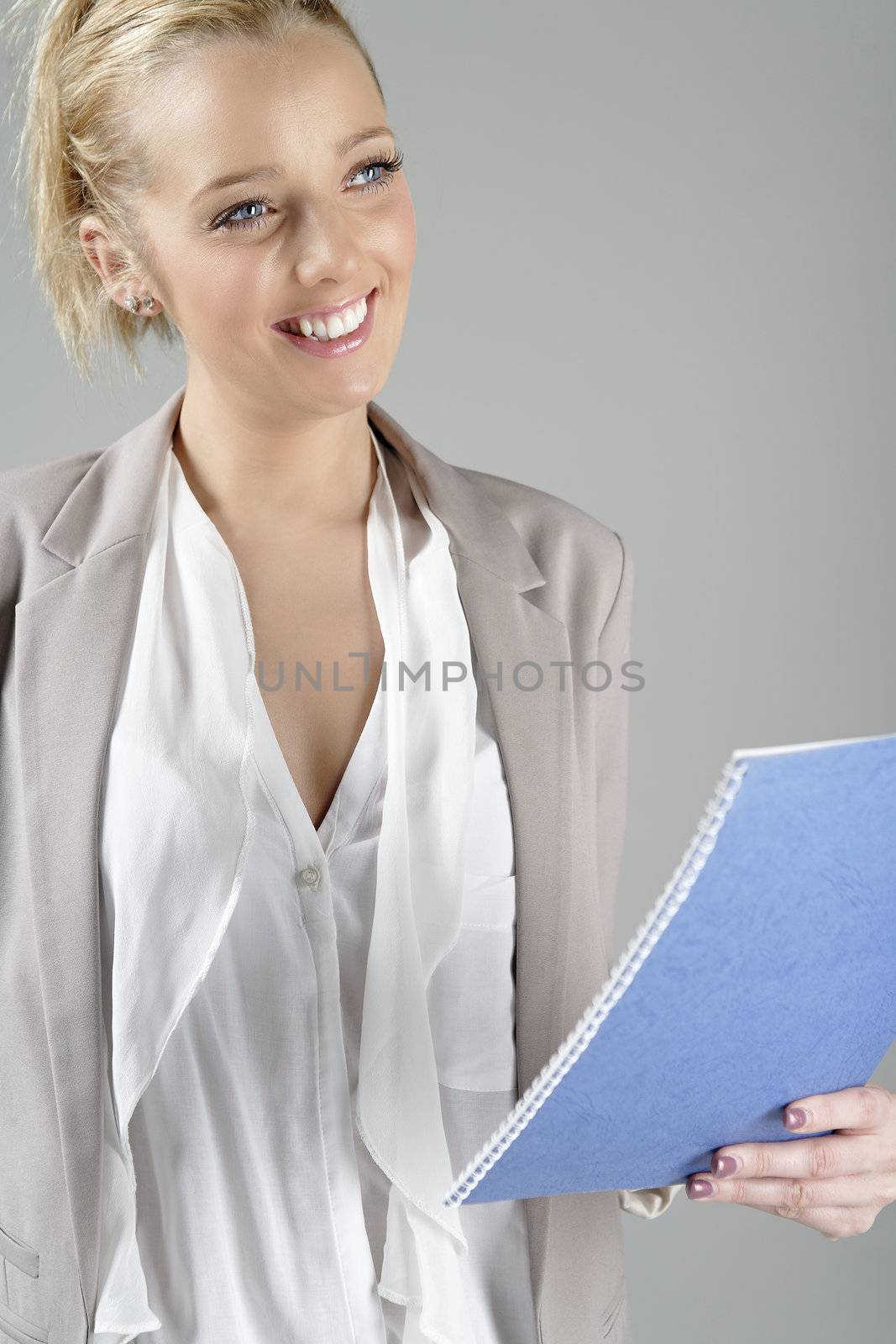Young beautiful woman in a business suit reading documents.