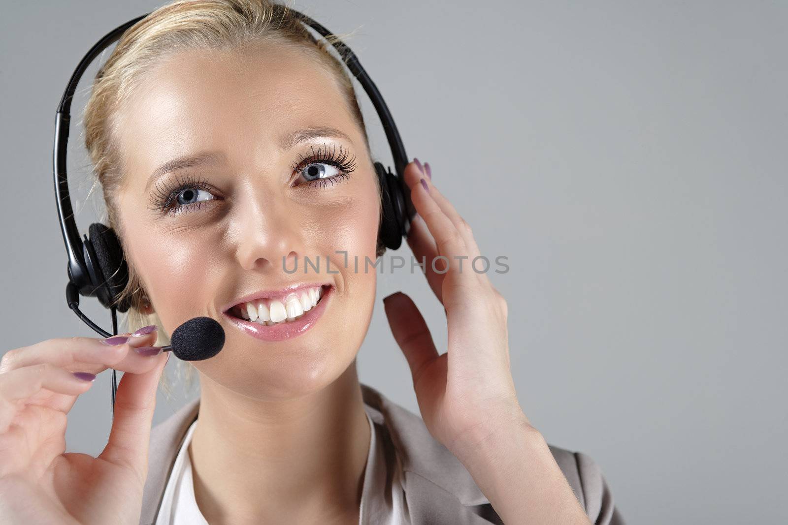 Call centre operator using a telephone headset.