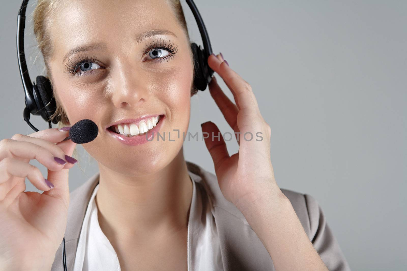 Woman wearing a headset at work by studiofi