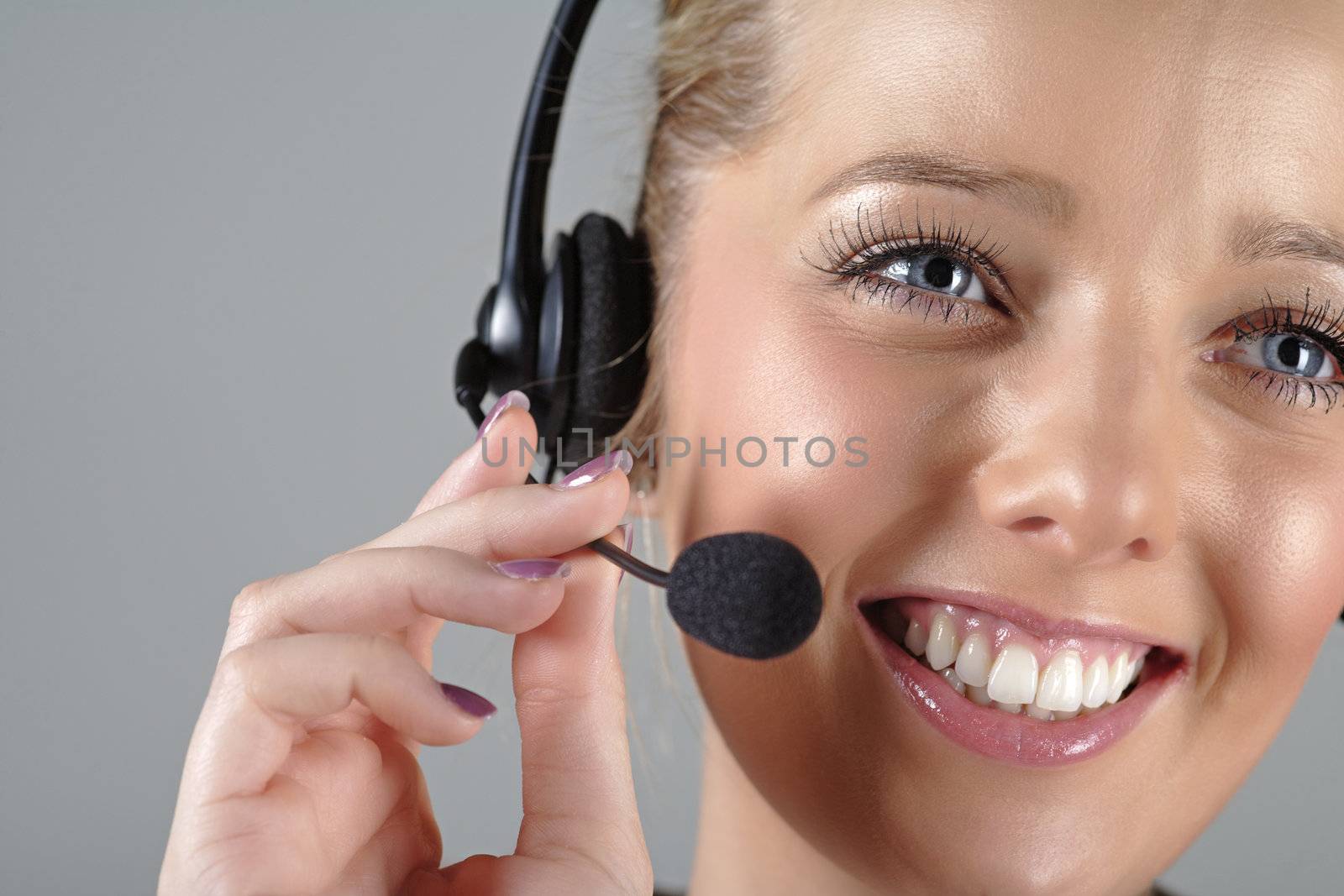 Woman wearing a headset at work by studiofi