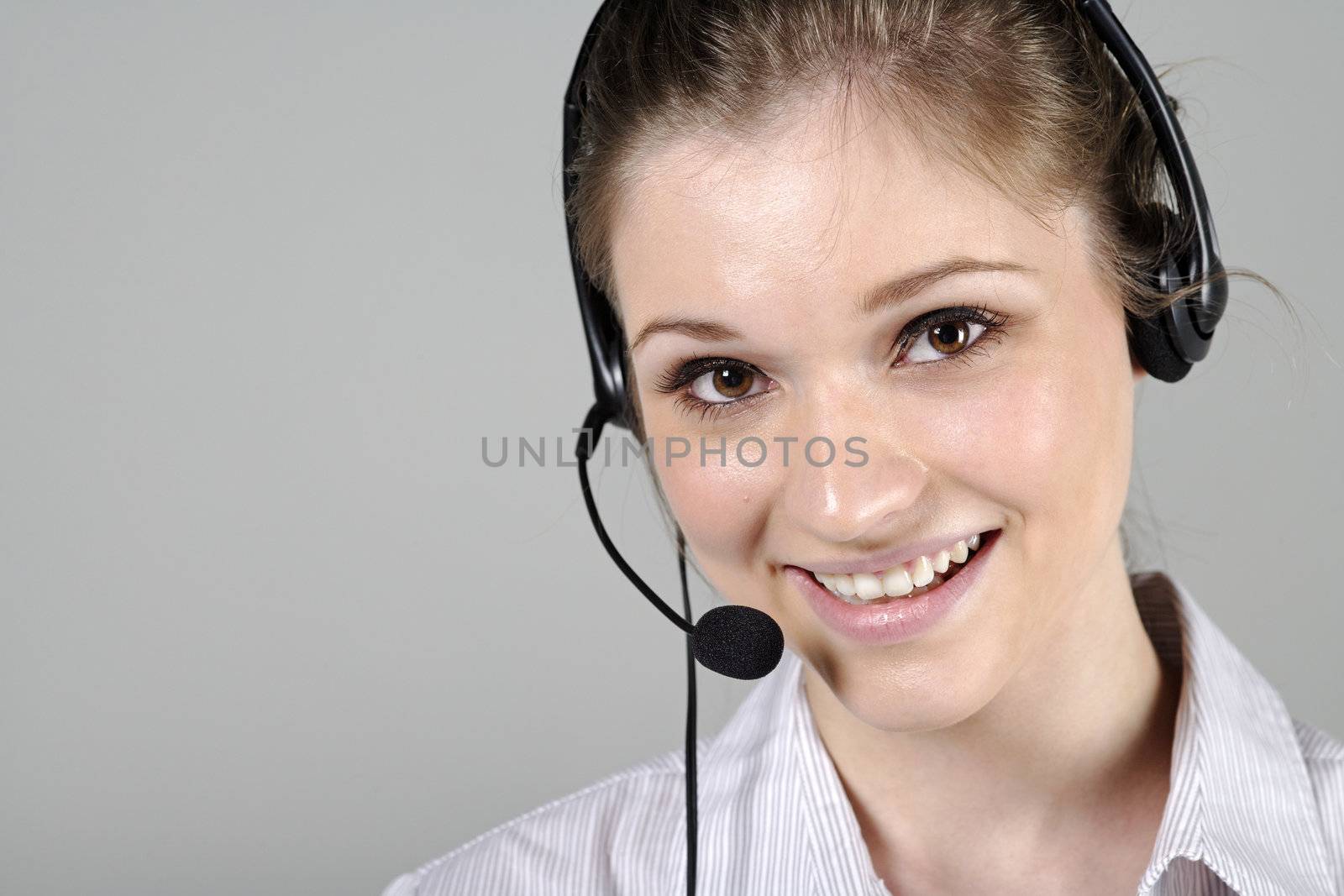 Young woman wearing a telephone headset talking on the phone