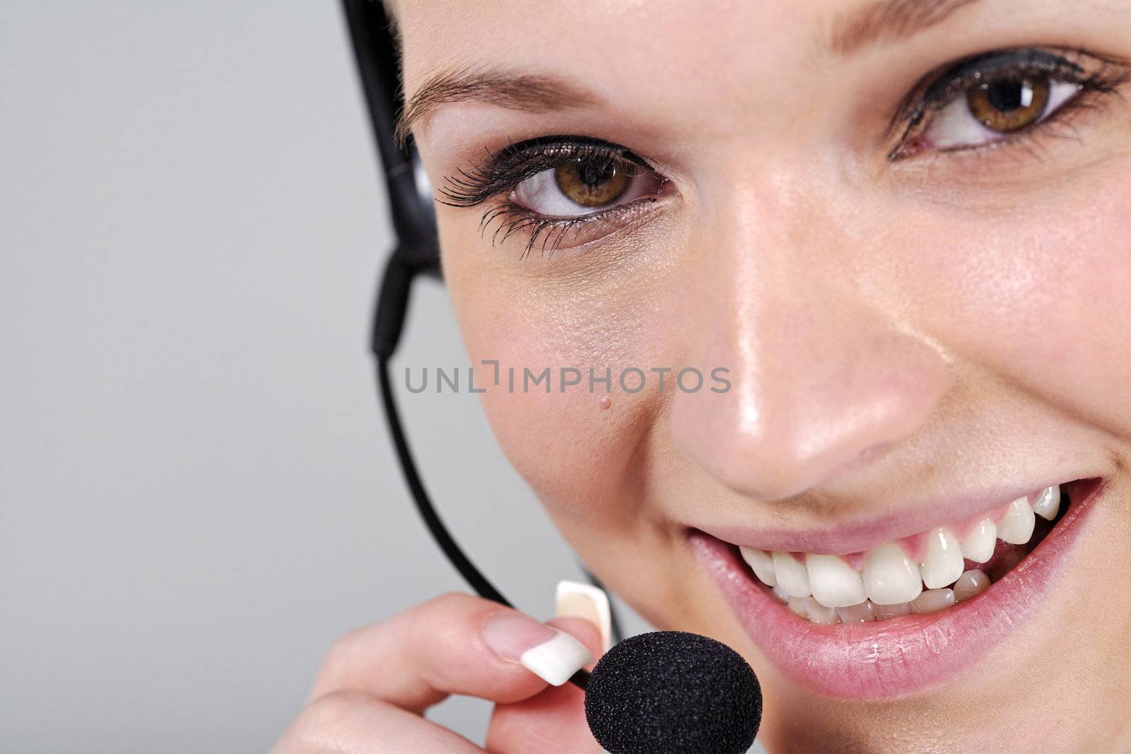 Young woman wearing a telephone headset talking on the phone